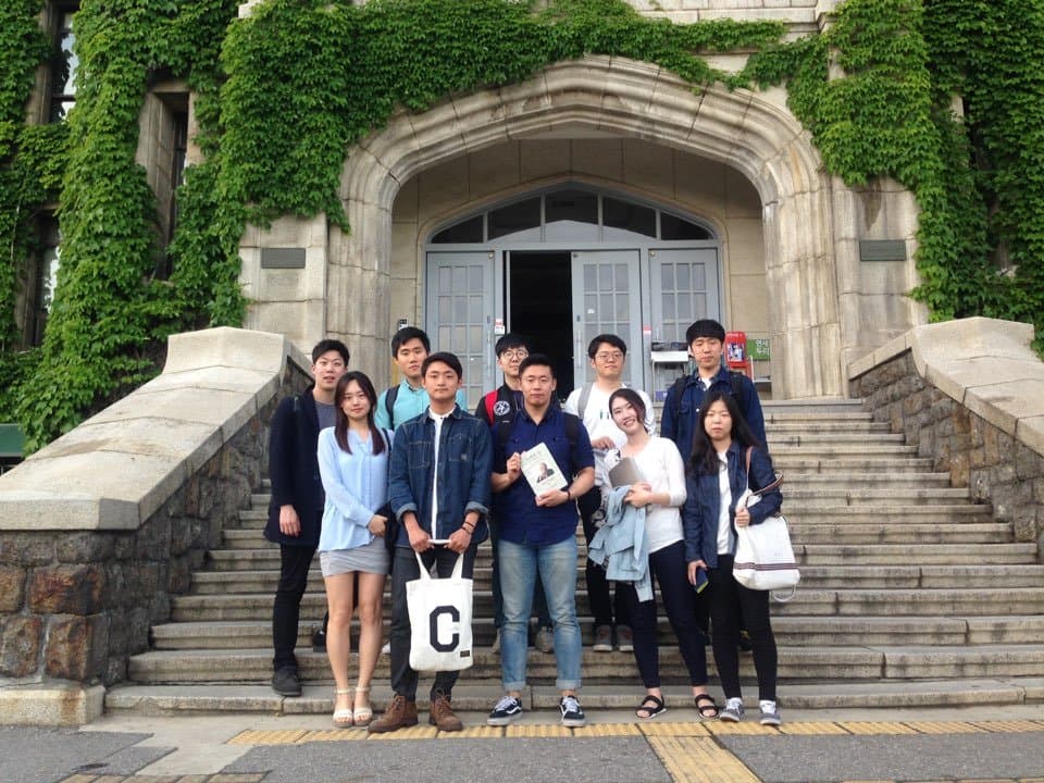 KB Kim with a book club group in front of a university building